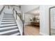 Bright foyer with staircase, view of the dining area, light hardwood floors, and white trim at 7006 Shooting Star Way, Myrtle Beach, SC 29579