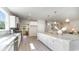 Bright kitchen features stainless steel appliances, a large island, white cabinets, and light hardwood floors at 7006 Shooting Star Way, Myrtle Beach, SC 29579