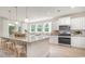 Modern kitchen with a large island, white cabinets, stainless steel appliances, and pendant lighting at 7006 Shooting Star Way, Myrtle Beach, SC 29579
