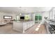 Open concept kitchen with a large island, granite countertop, white cabinets, and stainless steel appliances at 7006 Shooting Star Way, Myrtle Beach, SC 29579