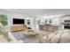 Open-concept living area with a view of the kitchen, featuring modern furnishings and abundant natural light at 7006 Shooting Star Way, Myrtle Beach, SC 29579