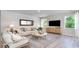 Well-lit living room offers a comfortable seating area, modern decor, and a large window, creating an inviting atmosphere at 7006 Shooting Star Way, Myrtle Beach, SC 29579