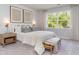 Comfortable main bedroom with a decorative headboard, soft lighting, and a large window overlooking the trees outside at 7006 Shooting Star Way, Myrtle Beach, SC 29579