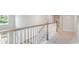 Upstairs hallway with a railing overlooking the stairs and a view through the window over the front yard at 7006 Shooting Star Way, Myrtle Beach, SC 29579