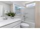 Bright bathroom featuring a shower-tub combo, modern fixtures and coastal decor at 7011 Shooting Star Way, Myrtle Beach, SC 29579