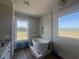Modern bathroom with freestanding tub, marble tile, and natural light at 713 Horry Rd., Conway, SC 29526