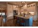 Gorgeous kitchen featuring white cabinets, stone counters, blue island, and pendant lighting at 713 Horry Rd., Conway, SC 29526