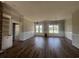 Living room featuring wood floors, built-in shelves and abundant natural light at 713 Horry Rd., Conway, SC 29526