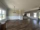 Spacious living room with wood floors, large windows, and modern chandelier at 713 Horry Rd., Conway, SC 29526