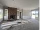 Open-concept living area showcasing a brick fireplace and built-in shelves, still under construction at 713 Horry Rd., Conway, SC 29526