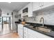 Bright kitchen featuring white cabinetry, granite countertops, and a decorative backsplash at 7509 N Ocean Blvd. # 1203, Myrtle Beach, SC 29572