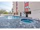 Swimming pool and hot tub next to the building with convenient access to the beach and nearby amenities at 7509 N Ocean Blvd. # 1203, Myrtle Beach, SC 29572