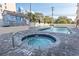Hot tub next to a pool with outdoor seating surrounded by a well-kept deck and lush landscaping at 7509 N Ocean Blvd. # 1203, Myrtle Beach, SC 29572