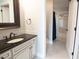 Bathroom featuring granite countertop vanity, brushed bronze fixtures, and access to the shower at 9547 Edgerton Dr. # 204, Myrtle Beach, SC 29572
