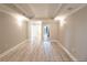 Large bedroom with neutral paint, vinyl floors, tray ceiling, and recessed lighting at 9547 Edgerton Dr. # 204, Myrtle Beach, SC 29572