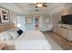 Bedroom features wood floors, king bed, dresser, and tray ceiling with fan at 9547 Edgerton Dr. # 204, Myrtle Beach, SC 29572