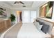 Bright bedroom with ceiling fan, tray ceiling, neutral walls, art, and door to the en suite bath at 9547 Edgerton Dr. # 204, Myrtle Beach, SC 29572