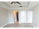 Open bedroom with wood floors, ceiling fan, and access to a bathroom and closet space at 9547 Edgerton Dr. # 204, Myrtle Beach, SC 29572