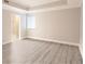 A bright bedroom with a large window and stylish light gray vinyl flooring at 9547 Edgerton Dr. # 204, Myrtle Beach, SC 29572
