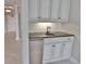 Wet bar area features white cabinets, granite countertop, and stainless steel refrigerator at 9547 Edgerton Dr. # 204, Myrtle Beach, SC 29572