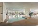 Indoor pool area featuring ample natural light, comfortable seating, and lush greenery at 9547 Edgerton Dr. # 204, Myrtle Beach, SC 29572