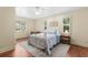 Bright main bedroom featuring hardwood floors, and three windows illuminating the room at 966 Waterway Ln., Myrtle Beach, SC 29572