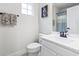 Well-lit bathroom features a white vanity, toilet, decorative towels and a shower with curtain at 101 Galil Dr. # A, Myrtle Beach, SC 29579