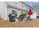 Outdoor patio with wicker furniture and red umbrella, perfect for enjoying outdoor meals at 101 Galil Dr. # A, Myrtle Beach, SC 29579