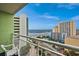 Balcony view overlooking the pool area and beach, complete with a white chair at 1105 South Ocean Blvd. # 852, Myrtle Beach, SC 29577