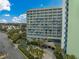 Hotel exterior featuring balconies and a pool area with palm trees from an aerial perspective at 1105 South Ocean Blvd. # 852, Myrtle Beach, SC 29577