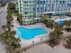 Exterior hotel view showcasing the pool, lounge chairs, palm trees, and building exterior at 1105 South Ocean Blvd. # 852, Myrtle Beach, SC 29577