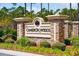 Stone entrance sign to Cameron Woods with manicured landscaping at 1145 Windy Grove Ln Sw # 16, Ocean Isle Beach, NC 28469