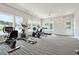 Brightly lit community gym with modern cardio equipment and large windows at 1145 Windy Grove Ln Sw # 16, Ocean Isle Beach, NC 28469