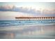 Scenic view of a wooden pier stretching out into the ocean under a cloudy sky at 1145 Windy Grove Ln Sw # 16, Ocean Isle Beach, NC 28469