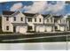 Newly built light gray townhomes with black roofs offer modern living spaces and attached garages at 1145 Windy Grove Ln Sw # 16, Ocean Isle Beach, NC 28469