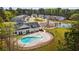 Community pool and clubhouse surrounded by lush landscaping and trees at 1149 Windy Grove Ln Sw # 15, Ocean Isle Beach, NC 28469