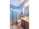 Bright bathroom with a shower, vanity, linen storage, and tiled floors at 1182 Palm Crossing Dr., Little River, SC 29566