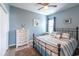 Serene bedroom with blue walls, a metal frame bed, and a vintage dresser at 1182 Palm Crossing Dr., Little River, SC 29566