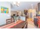 Open-concept dining room showcasing modern lighting, neutral walls, and hardwood flooring extending into the adjacent kitchen and living area at 1182 Palm Crossing Dr., Little River, SC 29566