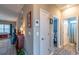 Hallway with neutral walls, hardwood flooring, a doorway leading to a bedroom, and a glimpse of a living room at 1182 Palm Crossing Dr., Little River, SC 29566