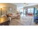 Open-concept living room with a comfortable sofa, ceiling fan, and lots of natural light at 1182 Palm Crossing Dr., Little River, SC 29566