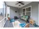 Outdoor covered porch with ceiling fan, comfortable seating, and relaxing ambiance at 1182 Palm Crossing Dr., Little River, SC 29566