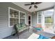 Cozy screened-in porch featuring ample seating and views of the yard at 1182 Palm Crossing Dr., Little River, SC 29566