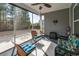 Screened in porch with neutral paint, ceiling fan and a view of the backyard at 1182 Palm Crossing Dr., Little River, SC 29566
