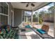 Inviting screened-in porch with wicker furniture and an open view of the landscaped yard at 1182 Palm Crossing Dr., Little River, SC 29566