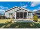 A cozy screened porch, perfect for relaxing, enhances the backyard view of this lovely home at 1182 Palm Crossing Dr., Little River, SC 29566