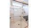 Modern shower with clear glass doors, built-in shelving, and a rainfall shower head in a brightly lit setting at 1182 Palm Crossing Dr., Little River, SC 29566