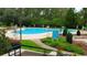 Community pool with tables, chairs, umbrellas, and a grass path at 1221 Tidewater Dr. # 2821, North Myrtle Beach, SC 29582