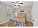 Bedroom features a ceiling fan and views from the window and a pelican decoration at 133 Puffin Dr. # 3-E, Pawleys Island, SC 29585