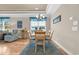 Bright dining room with six chairs, hardwood floors, and tray ceiling at 133 Puffin Dr. # 3-E, Pawleys Island, SC 29585